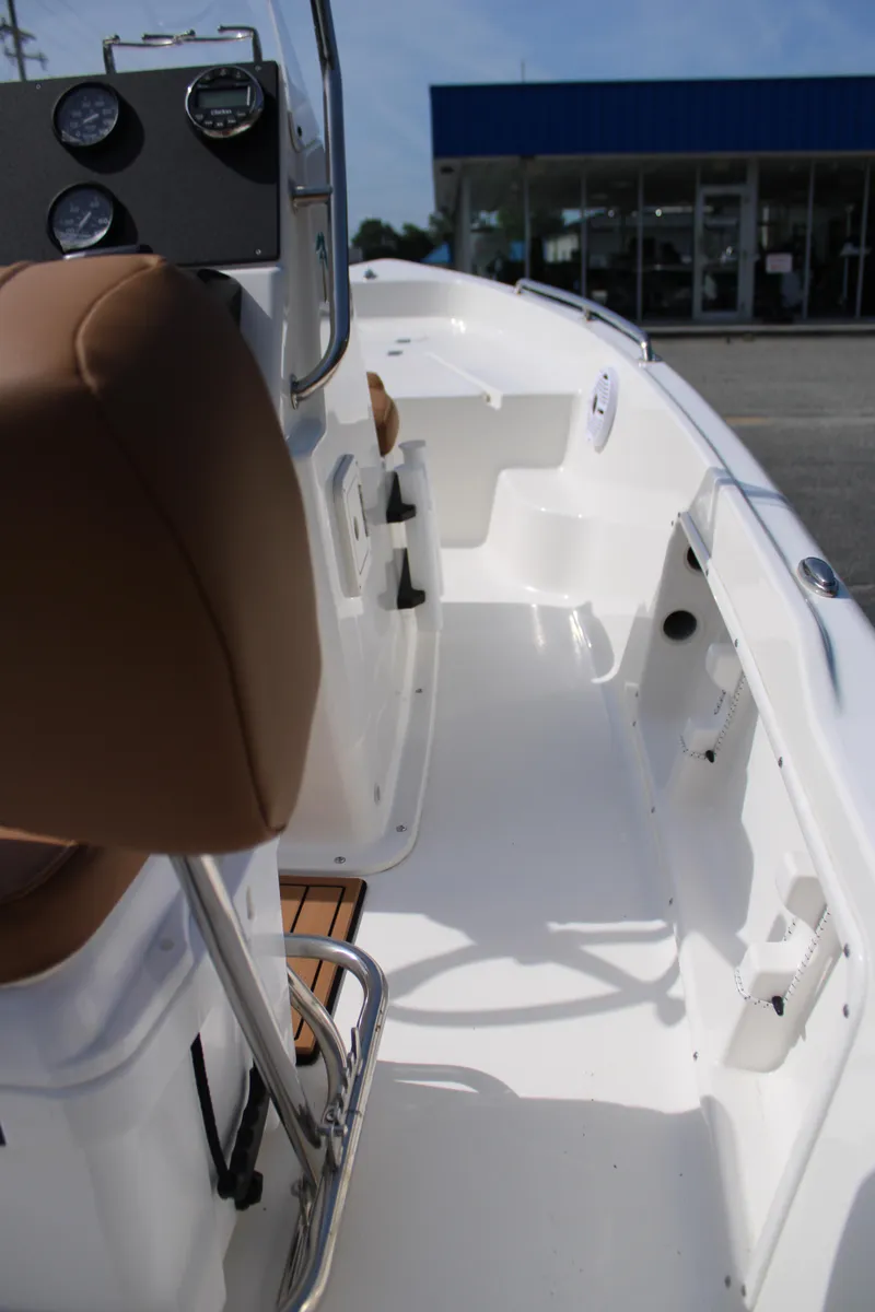 Slide: The Image of 2025 Key West 1720 Center Console boat interior with brown seating and white deck. - 18