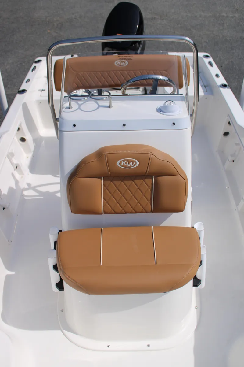 Slide: The Image of 2025 Key West 1720 Center Console boat with tan seating and steering console. - 19