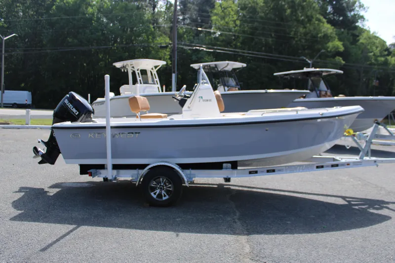 Slide: The Image of 2025 Key West 1720 Center Console boat on trailer, parked outdoors. - 2