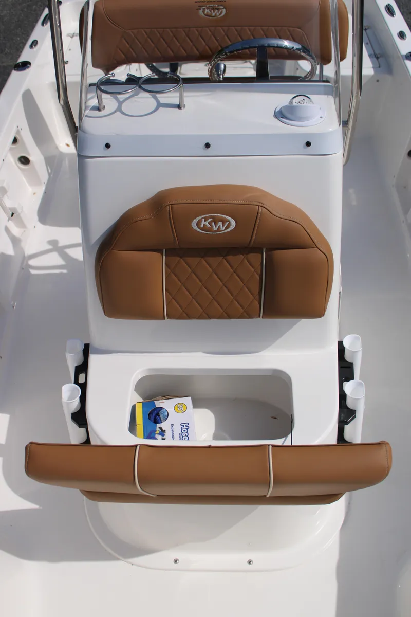 Slide: The Image of 2025 Key West 1720 Center Console boat interior with tan seating and storage compartment. - 20