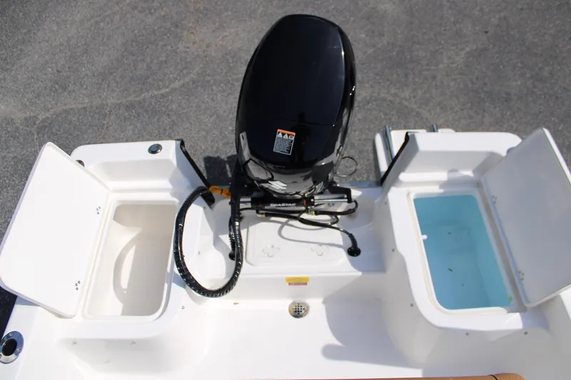 Slide: The Image of 2025 Key West 1720 Center Console boat with open storage compartments and outboard motor. - 26