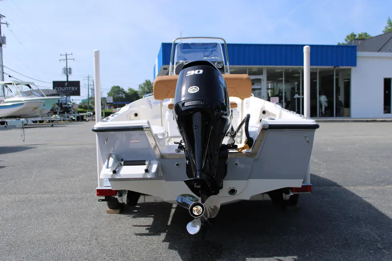 Slide: The Image of 2025 Key West 1720 Center Console boat with 90 HP engine, displayed outdoors. - 5