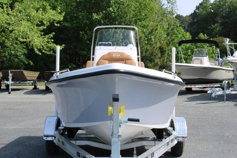 Slide: The Image of 2025 Key West 1720 Center Console boat on trailer, surrounded by greenery. - 6