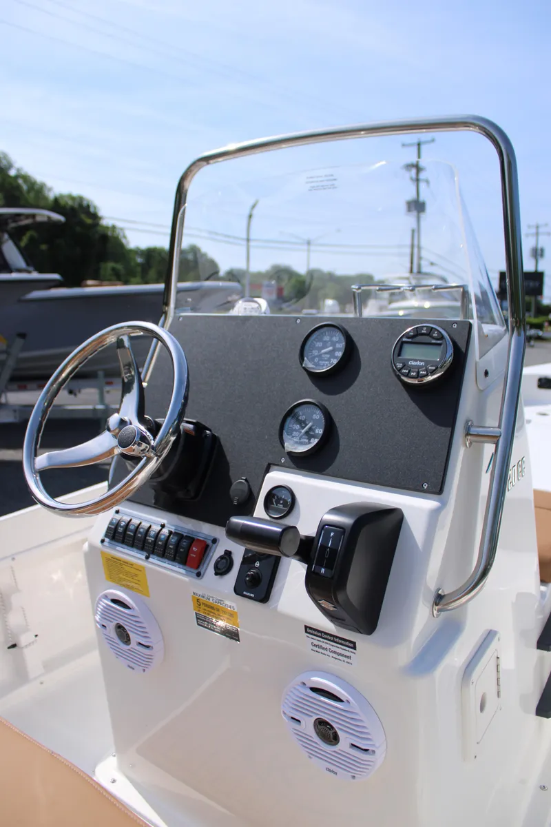 Slide: The Image of 2025 Key West 1720 Center Console boat dashboard with steering wheel and gauges. - 7