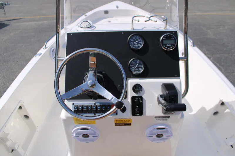 Slide: The Image of 2025 Key West 1720 Center Console boat dashboard with steering wheel and gauges. - 8