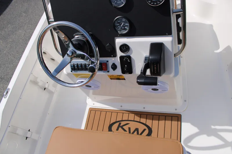 Slide: The Image of 2025 Key West 1720 Center Console boat dashboard with steering wheel and controls. - 9