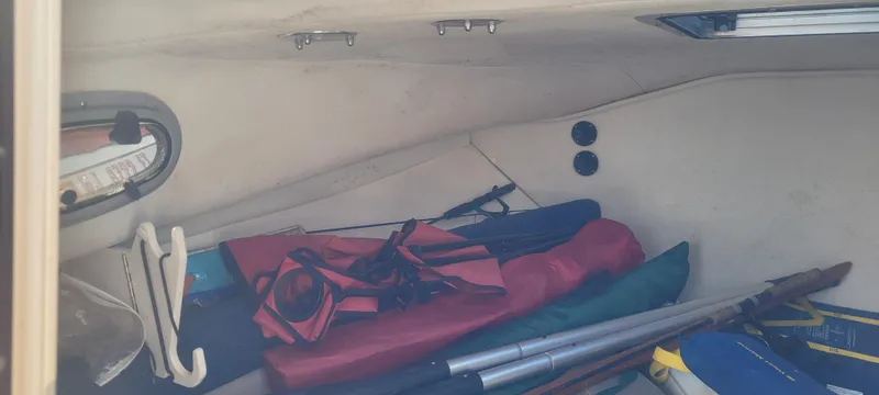 Slide: The Image of Interior cabin of 1999 Boston Whaler 23 Conquest with stored gear and equipment. - 10