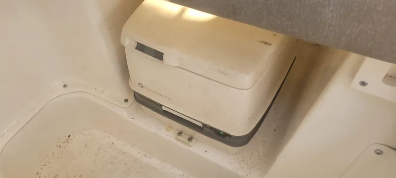 Slide: The Image of Portable toilet in a 1999 Boston Whaler 23 Conquest boat interior. - 11