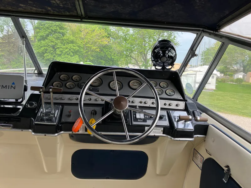 Slide: The Image of 1985 Cruisers 336 Ultra Vee boat helm with steering wheel and control panel. - 11