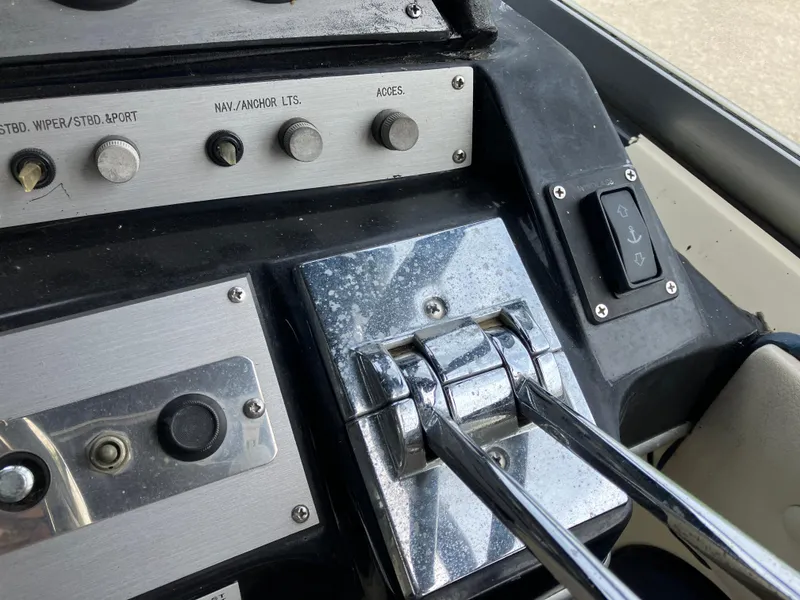 Slide: The Image of Control panel of a 1985 Cruisers 336 Ultra Vee boat with levers and buttons. - 14