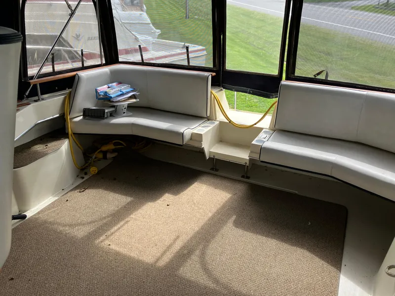 Slide: The Image of 1985 Cruisers 336 Ultra Vee boat interior with white seating and carpeted floor. - 15