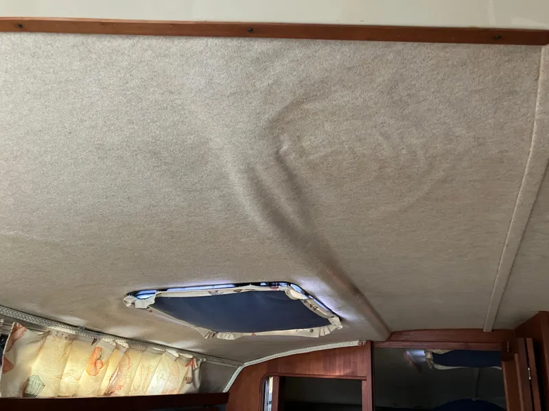 Slide: The Image of Interior ceiling of 1985 Cruisers 336 Ultra Vee boat with hatch and wood trim. - 20
