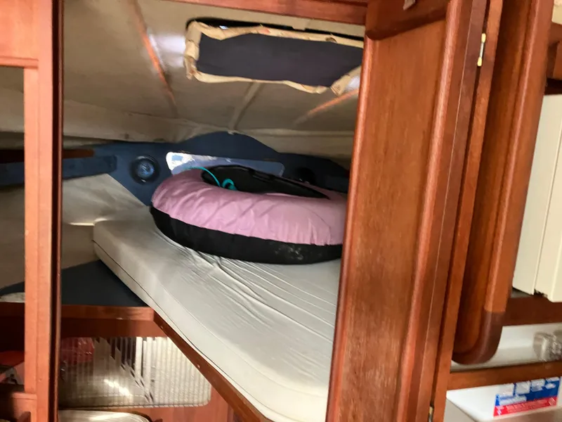Slide: The Image of 1985 Cruisers 336 Ultra Vee cabin interior with wooden cabinetry and mattress. - 21