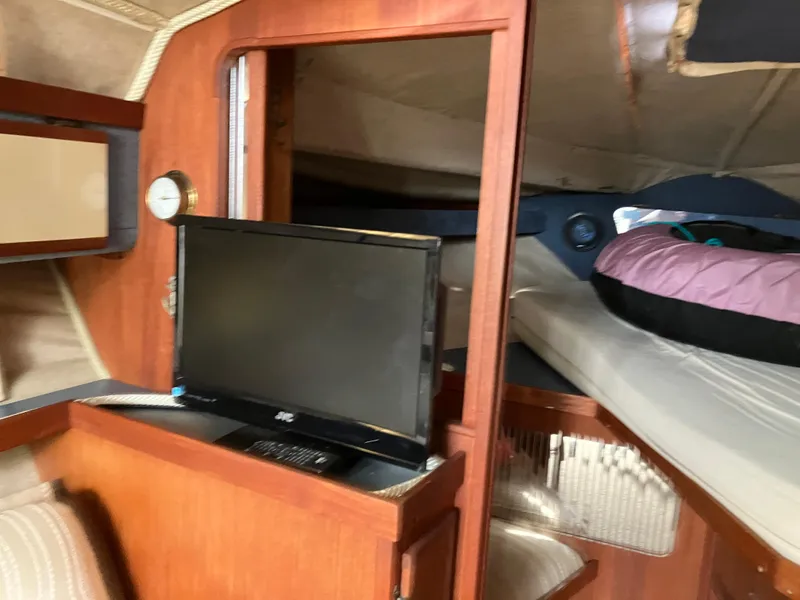 Slide: The Image of Interior of 1985 Cruisers 336 Ultra Vee boat with TV and sleeping area. - 22