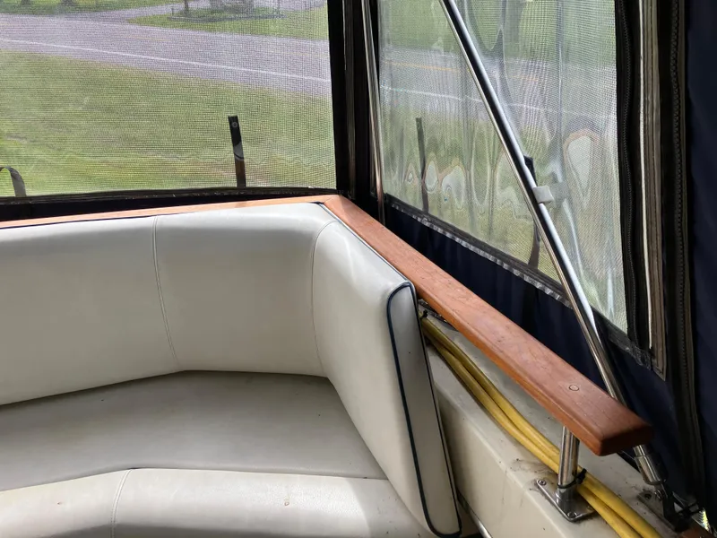 Slide: The Image of 1985 Cruisers 336 Ultra Vee boat interior with white seating and wooden trim. - 33