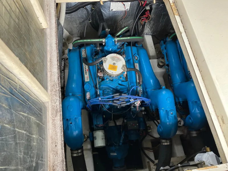Slide: The Image of 1985 Cruisers 336 Ultra Vee engine compartment with blue marine engines. - 34