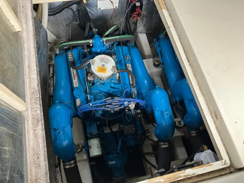 Slide: The Image of 1985 Cruisers 336 Ultra Vee engine compartment with blue marine engine components. - 35