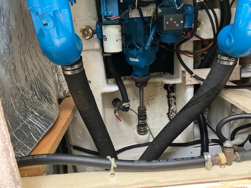 Slide: The Image of Engine compartment of 1985 Cruisers 336 Ultra Vee with visible hoses and components. - 36