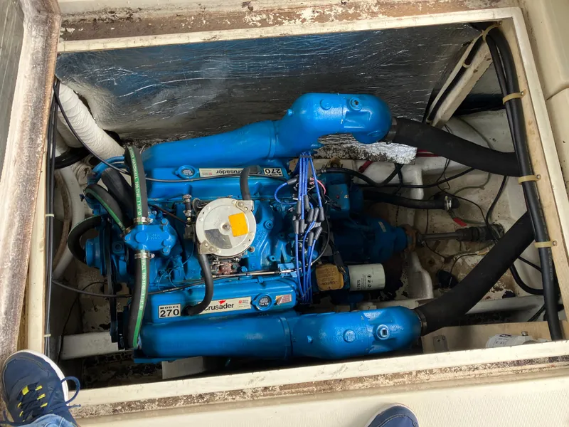 Slide: The Image of Engine compartment of a 1985 Cruisers 336 Ultra Vee boat, featuring a blue marine engine. - 37