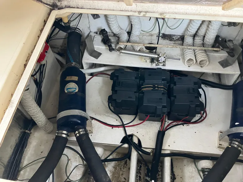 Slide: The Image of Engine compartment of 1985 Cruisers 336 Ultra Vee with visible hoses and battery boxes. - 39