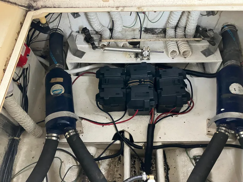 Slide: The Image of Engine compartment of 1985 Cruisers 336 Ultra Vee with visible wiring and components. - 40