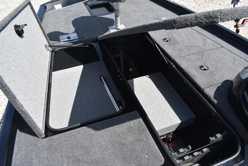 Slide: The Image of 2025 Lund 1875 Renegade SS boat interior storage compartments, open and carpeted. - 10