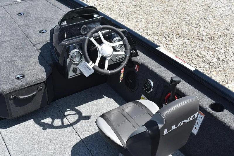 Slide: The Image of 2025 Lund 1875 Renegade SS boat interior with steering wheel and seating. - 11