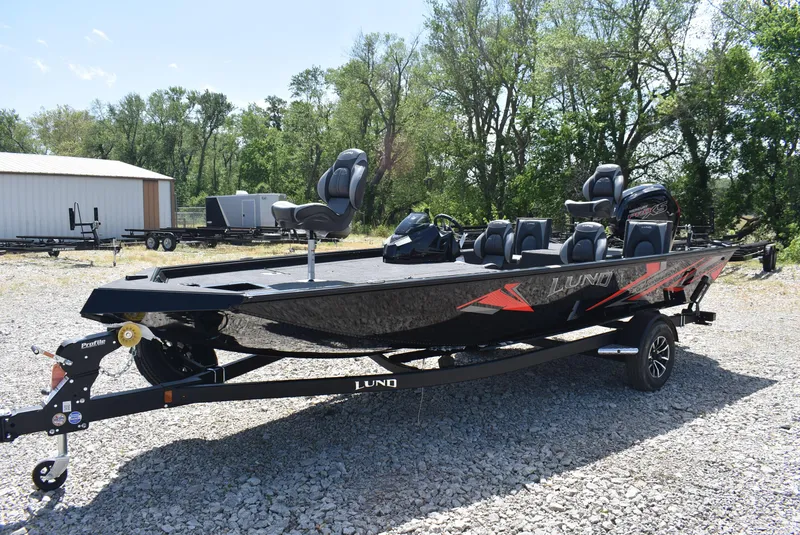 Slide: The Image of 2025 Lund 1875 Renegade SS boat on trailer, parked outdoors on gravel. - 3