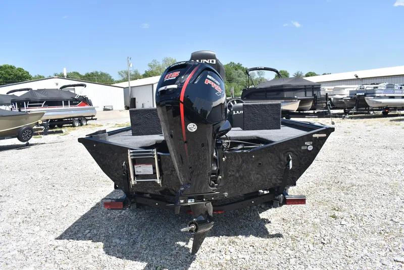 Slide: The Image of 2025 Lund 1875 Renegade SS boat with powerful outboard motor, parked on gravel lot. - 5