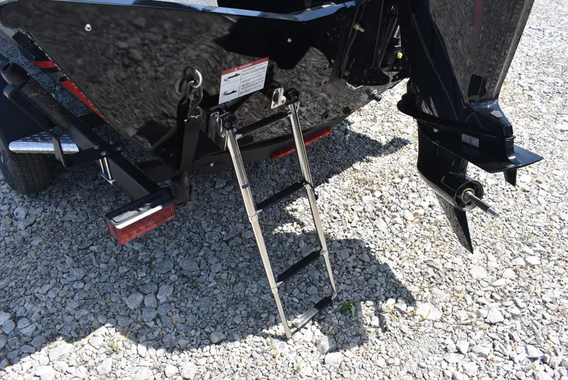 Slide: The Image of 2025 Lund 1875 Renegade SS boat with ladder on gravel surface. - 7