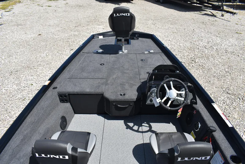 Slide: The Image of 2025 Lund 1875 Renegade SS boat interior with steering wheel and seating. - 8