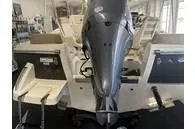 Slide: The Image of 2025 Scout 195 Sport Dorado boat with powerful outboard motor in showroom setting. - 5