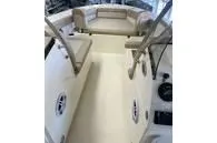 Slide: The Image of 2025 Scout 195 Sport Dorado boat interior with beige seating and steering console. - 8
