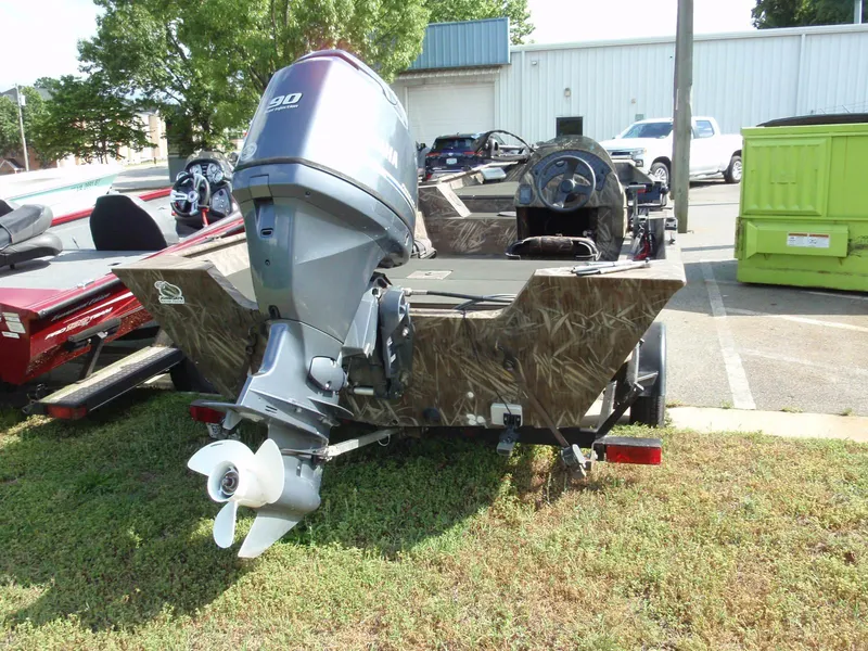 Slide: The Image of 2013 G3 1860 SC boat with outboard motor in a parking lot. - 4