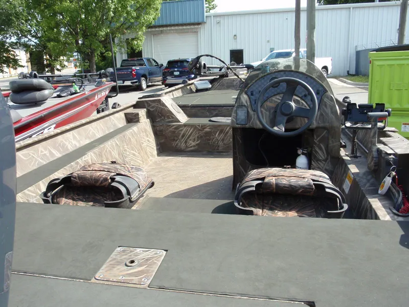 Slide: The Image of 2013 G3 1860 SC boat interior with steering console and camo seats. - 5