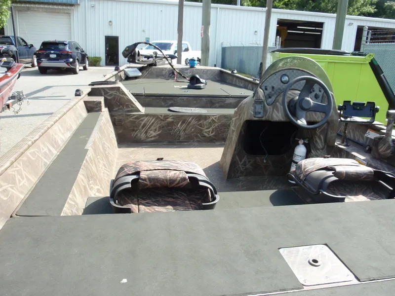 Slide: The Image of 2013 G3 1860 SC boat interior with camouflage seating and steering console. - 7