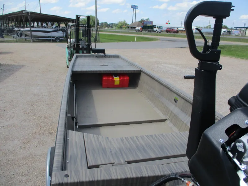 Slide: The Image of 2025 Gator Tail 1754 Extreme boat with open deck and storage, parked outdoors. - 4