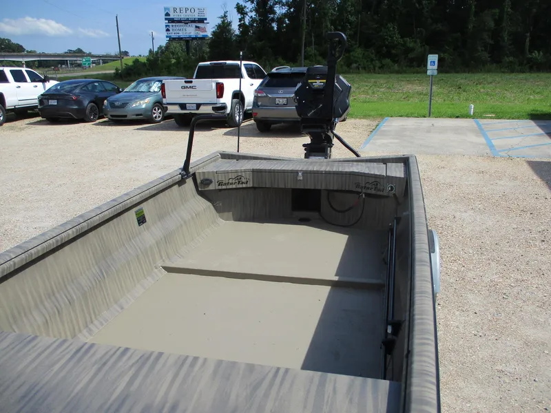 Slide: The Image of 2025 Gator Tail 1754 Extreme boat in parking lot, surrounded by cars and greenery. - 5