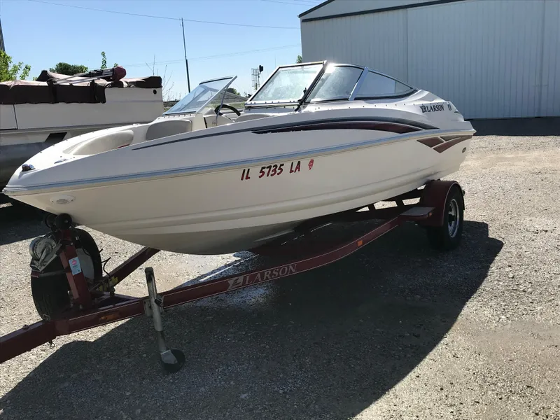 Slide: The Image of 2005 Larson Senza 186 I/O boat on trailer, parked outdoors. - 10