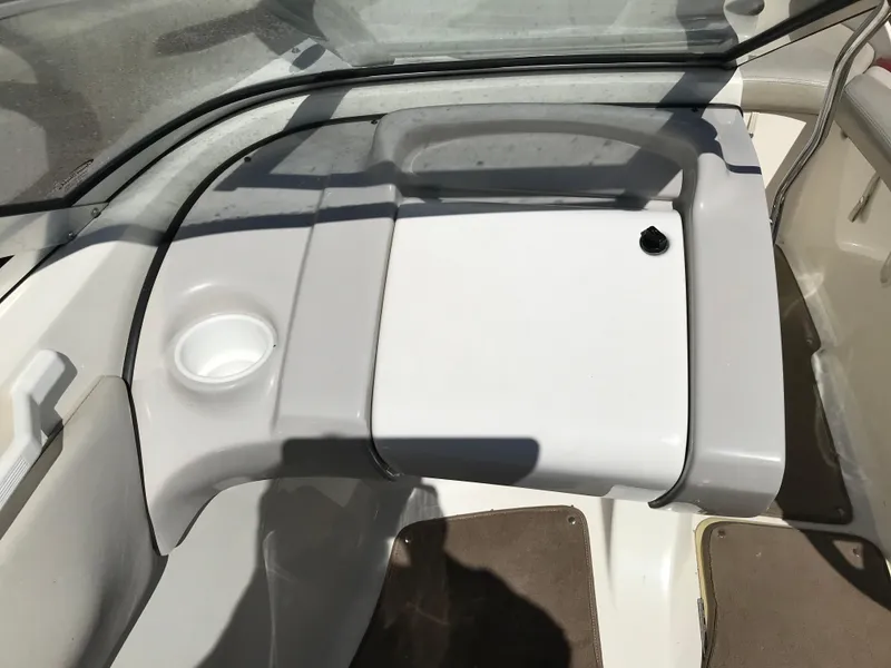 Slide: The Image of 2005 Larson Senza 186 I/O boat interior with cup holder and storage compartment. - 11