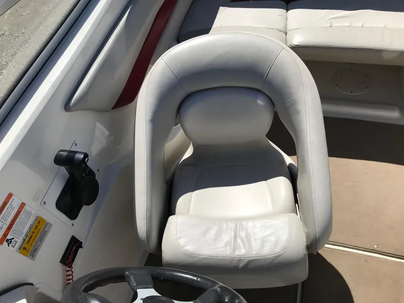 Slide: The Image of 2005 Larson Senza 186 I/O boat interior with white captain's chair and steering wheel. - 15