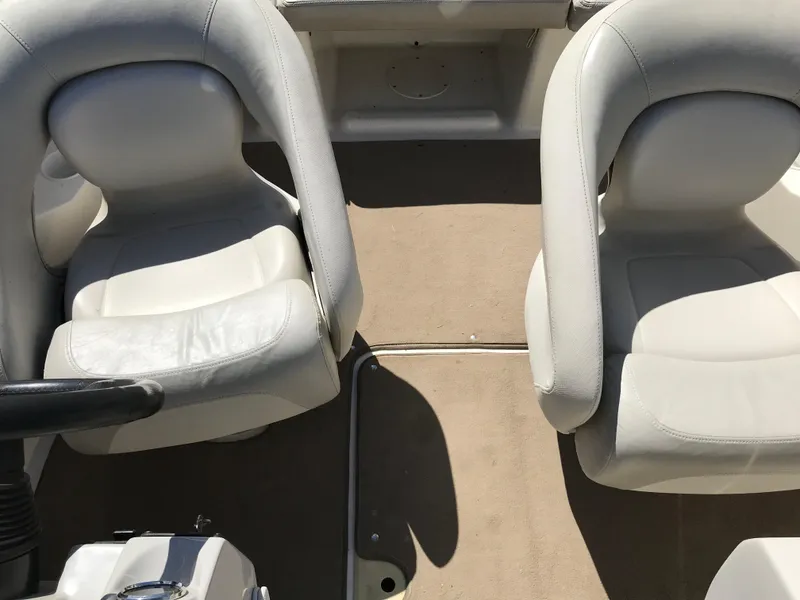 Slide: The Image of 2005 Larson Senza 186 I/O boat interior with two white seats and beige carpet. - 19