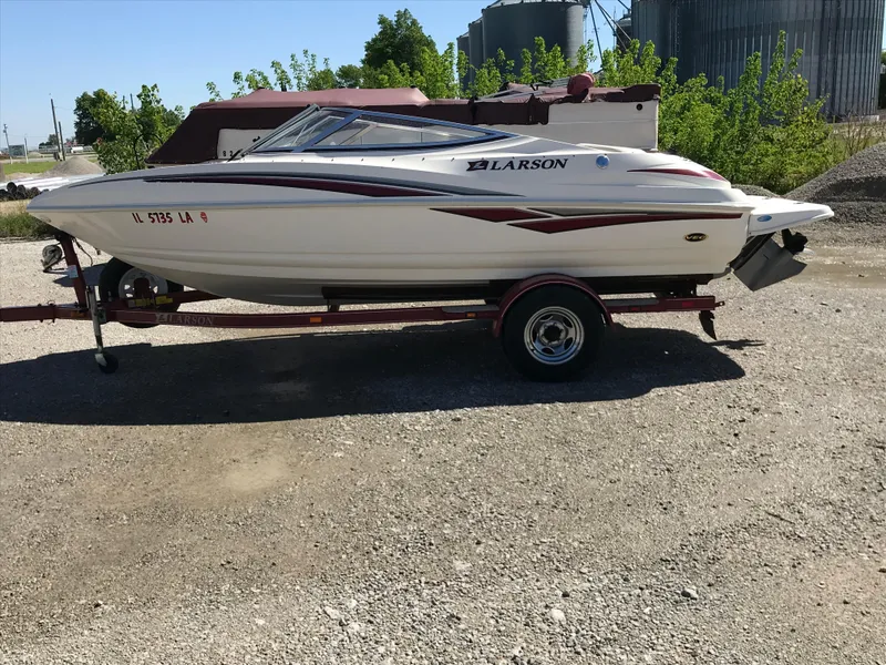Slide: The Image of 2005 Larson Senza 186 I/O boat on trailer, parked outdoors. - 2