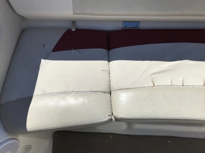 Slide: The Image of Worn upholstery on 2005 Larson Senza 186 I/O boat seat, showing visible stitching and wear. - 21