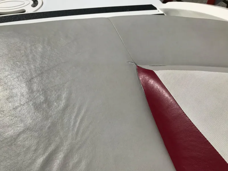 Slide: The Image of 2005 Larson Senza 186 I/O boat seat with gray and red upholstery detail. - 26