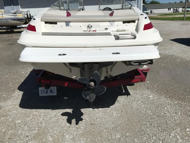 Slide: The Image of 2005 Larson Senza 186 I/O boat, rear view, on a trailer in a parking lot. - 3