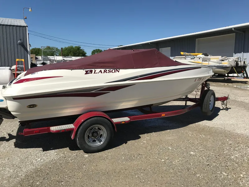 Slide: The Image of 2005 Larson Senza 186 I/O boat on trailer, covered, parked outdoors. - 33