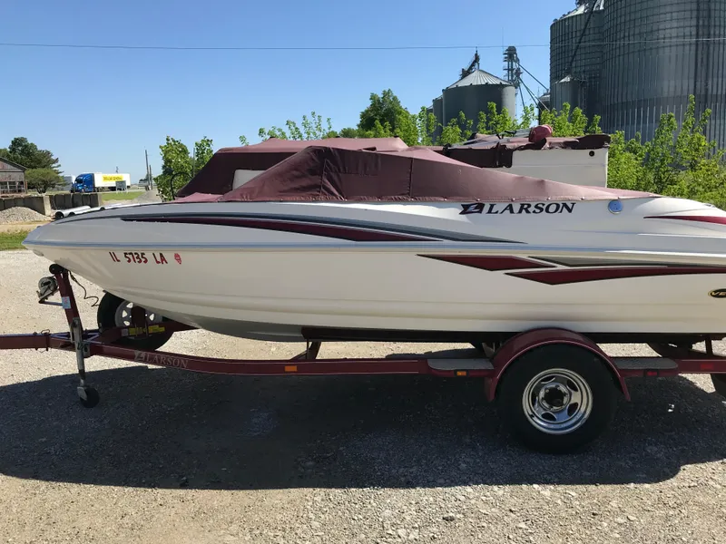Slide: The Image of 2005 Larson Senza 186 I/O boat on trailer, covered, parked outdoors. - 34