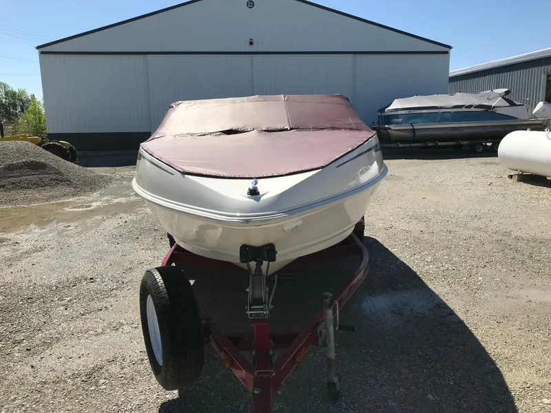 Slide: The Image of 2005 Larson Senza 186 I/O boat on trailer, covered, parked outdoors. - 35