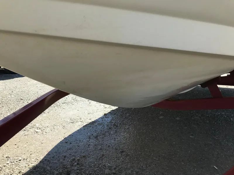 Slide: The Image of 2005 Larson Senza 186 I/O boat hull on a red trailer. - 36